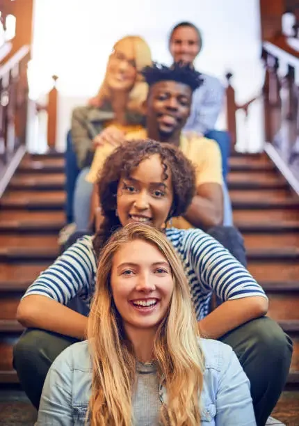 students sitting on steps happy